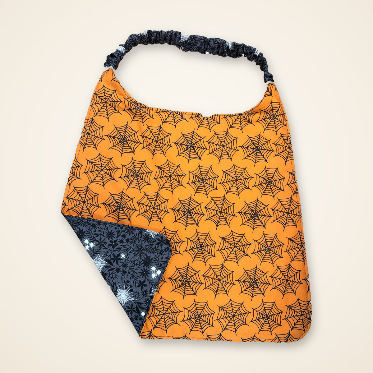 Orange Spiderweb / Gray Webs drool bib, orange spiderweb side
