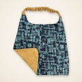 Teal Geometric / Gold Herringbone drool bib, teal side