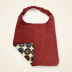 Brick Red / Penny Circles drool bib, red side