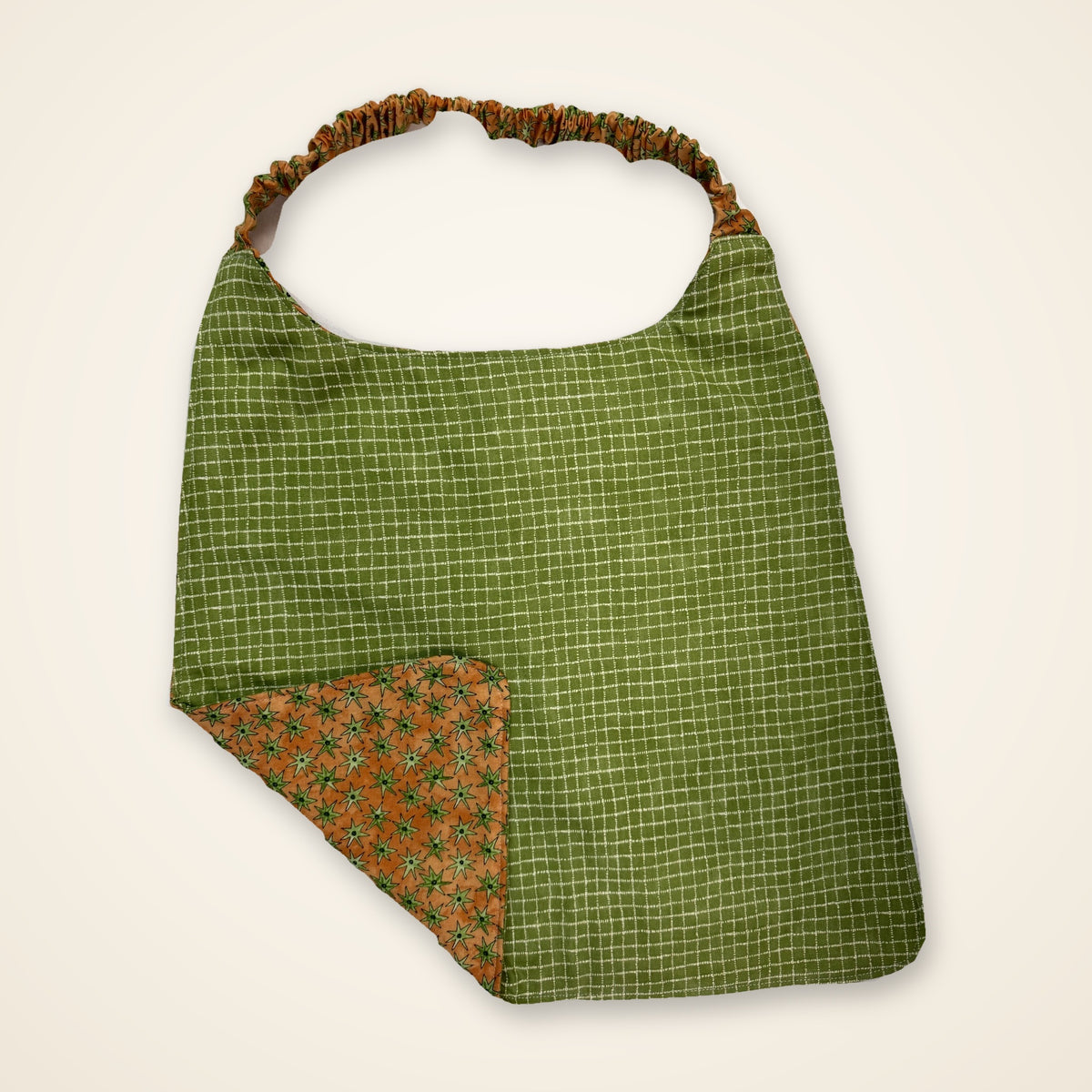 Green Grid / Orange Stars drool bib, green grid side