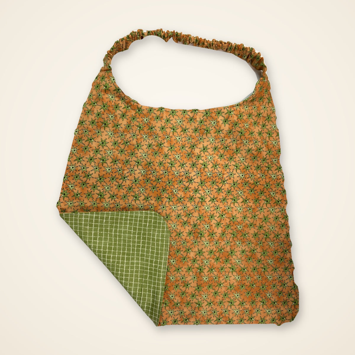 Green Grid / Orange Stars drool bib, orange star side