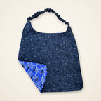 Purple Spiders / Black Stars drool bib, black stars side