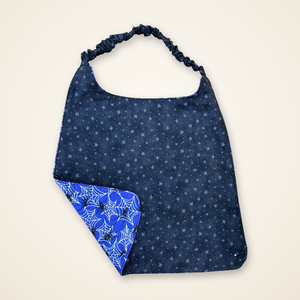 Purple Spiders / Black Stars drool bib, black stars side