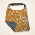 Orange Ghosts / Gray Geometric drool bib, orange ghost side